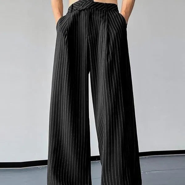 Black men's casual trousers with vertical stripes and front pleats laid flat.