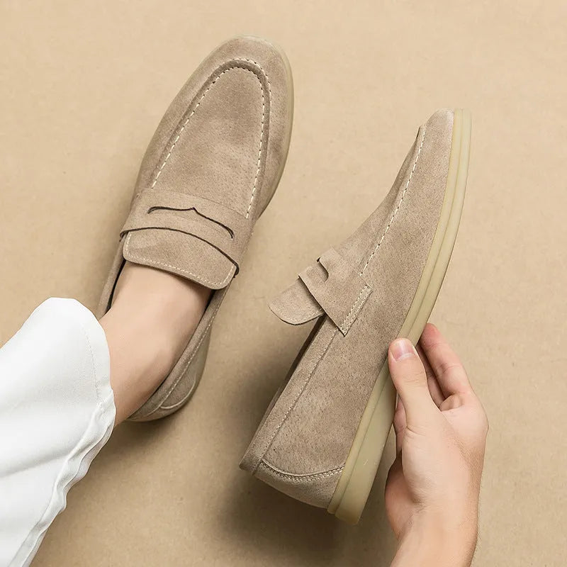 Men's beige leather slip-on shoes with a round toe and mid heel on a rubber sole.