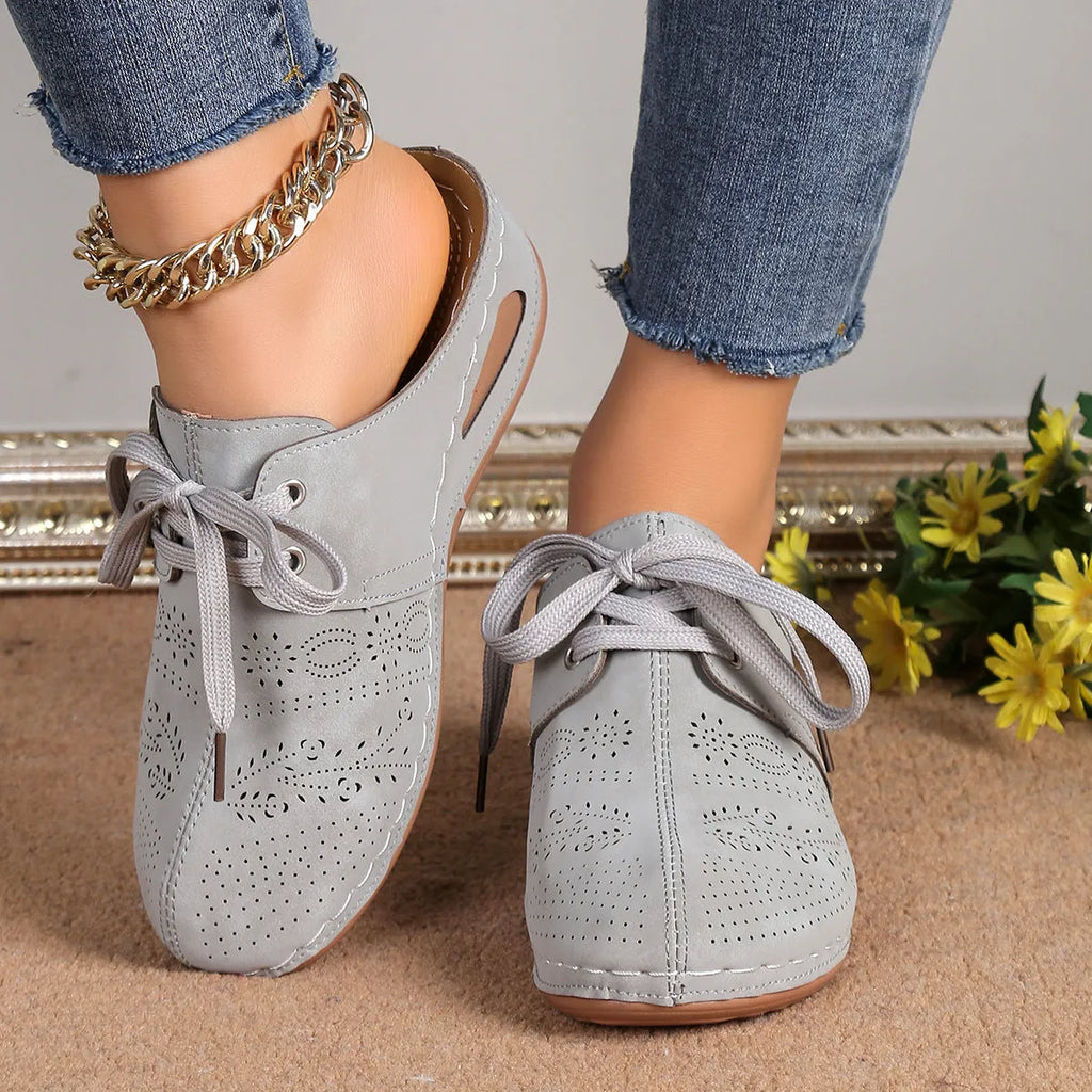 Women's suede lace-up wedge slippers in light grey with a hollow out design and rubber sole.