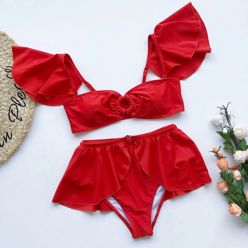 Women's red or black flounced three-piece bikini swimsuit on a mannequin.