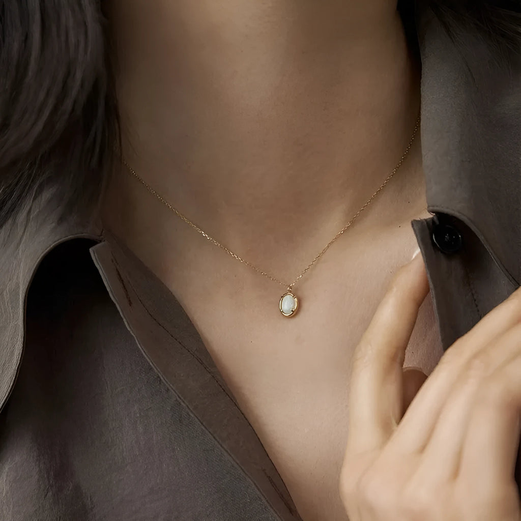 Oval geometric jelly opal pendant necklace with silver plating in gold or white gold colour.