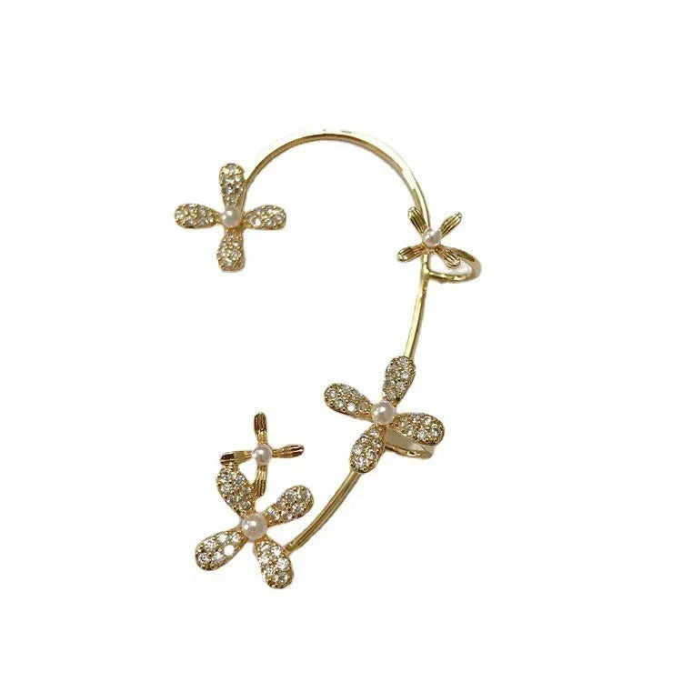 Sparkling zircon butterfly ear cuffs in gold-toned metal, featuring a delicate and elegant design for stylish accessorizing