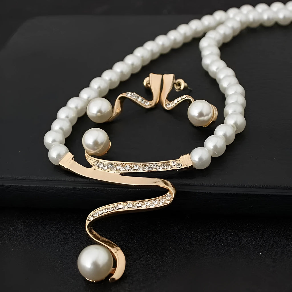 Gold electroplated pearl necklace and earrings set with drop-shaped pendant on deep V clavicle chain