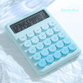 Dopamine gradient colour desk calculator in violet, pink, blue, and green on a white desk.
