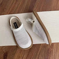 Beige linen slip-on shoes with mesh lining and a light rubber sole on a neutral background.
