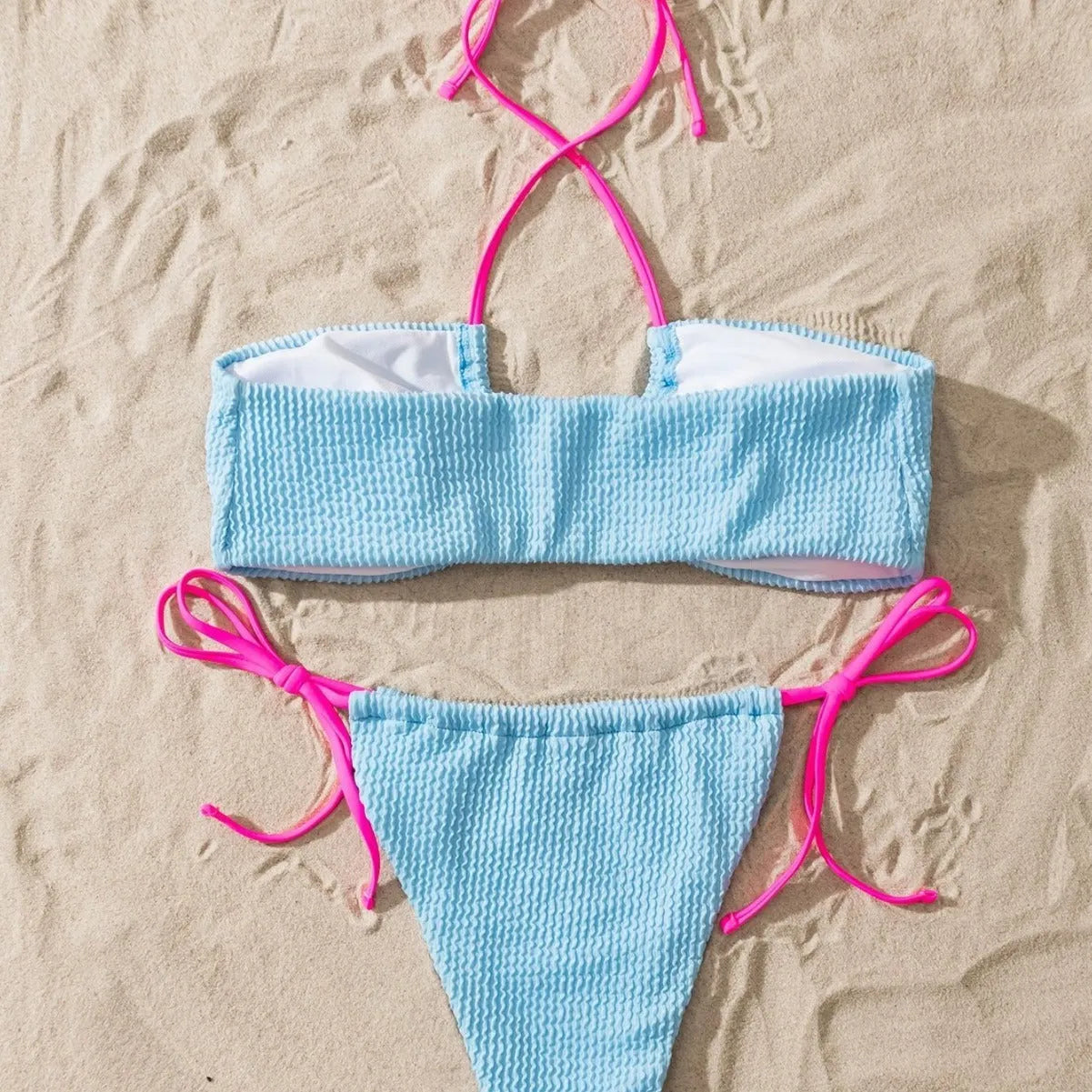Solid colour women's two-piece swimsuit with halter neck and lace-up back detail