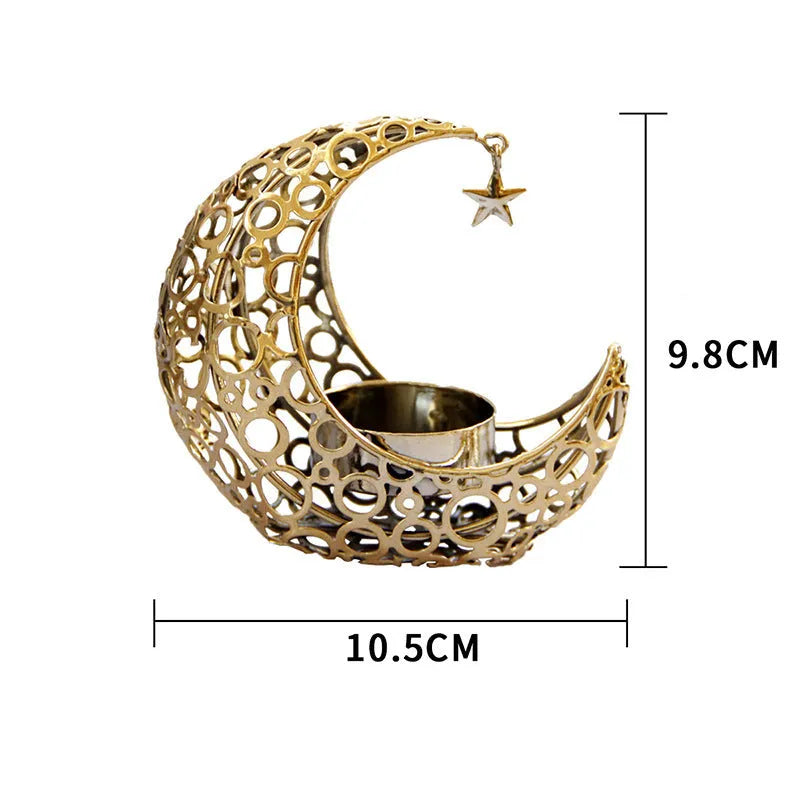 Black metal crescent moon candle holder with star cutouts on a table