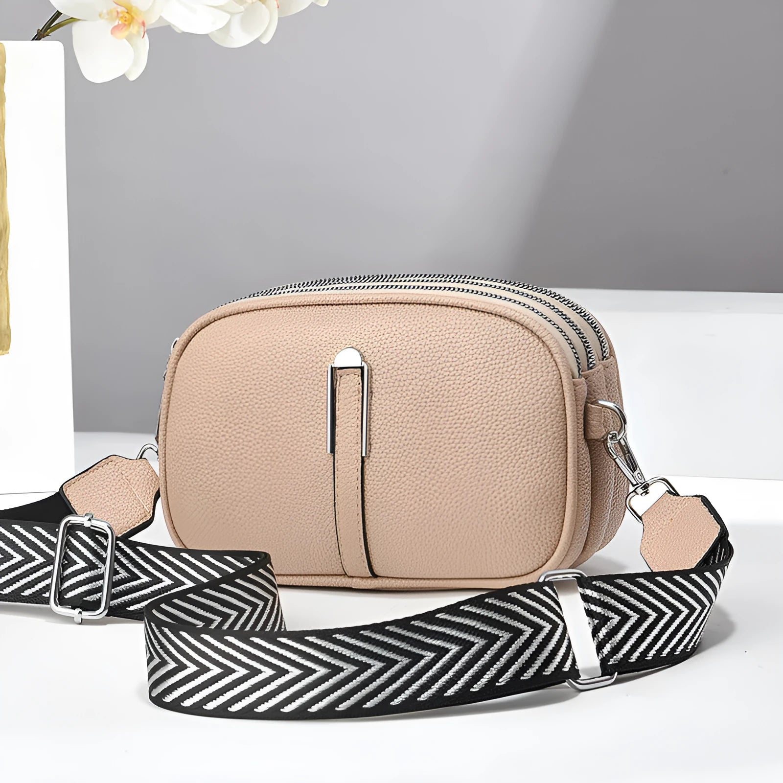 Soft oval PU leather crossbody handbag with stone pattern and internal organiser compartments.