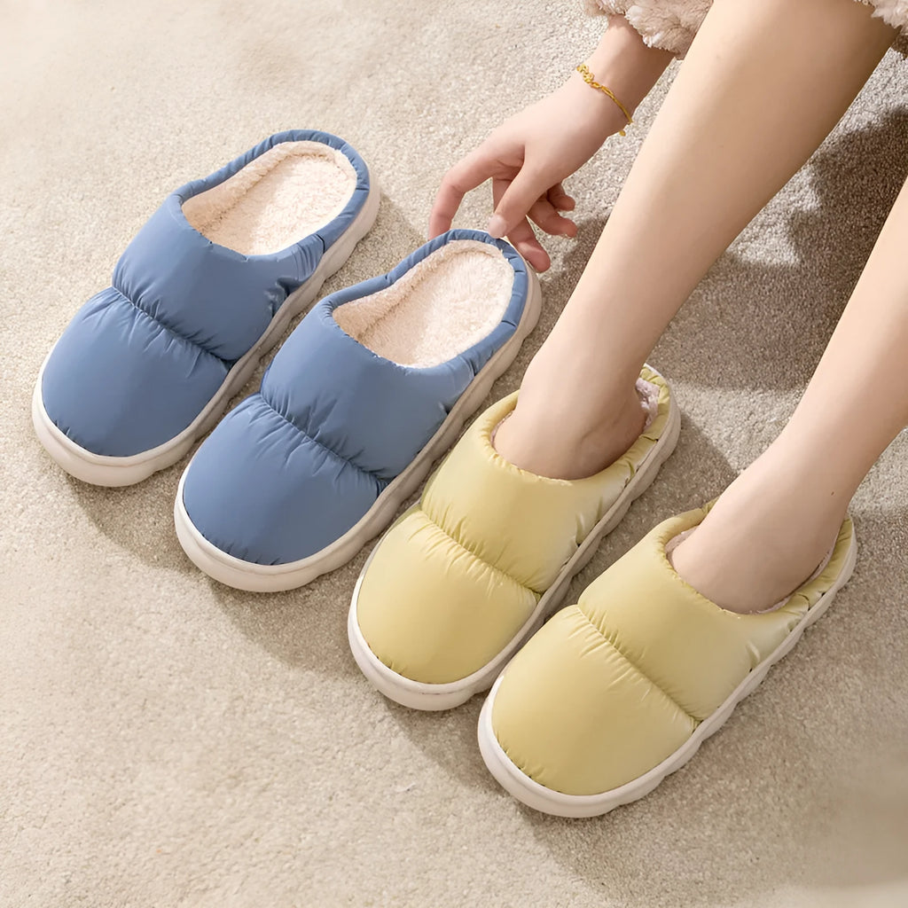 Blue thick-soled indoor slippers with artificial leather upper and plush lining on a rubber sole.
