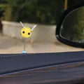 Small black and yellow cartoon bee car decoration with a spring, on a fur ball.