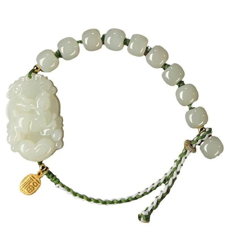 Hetian jade Rabbit charm bracelet on a red rope with a small silver blessing card.