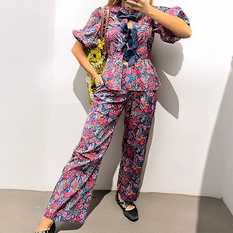 Floral print trousers suit with tie-neck puff sleeve blouse and matching trousers