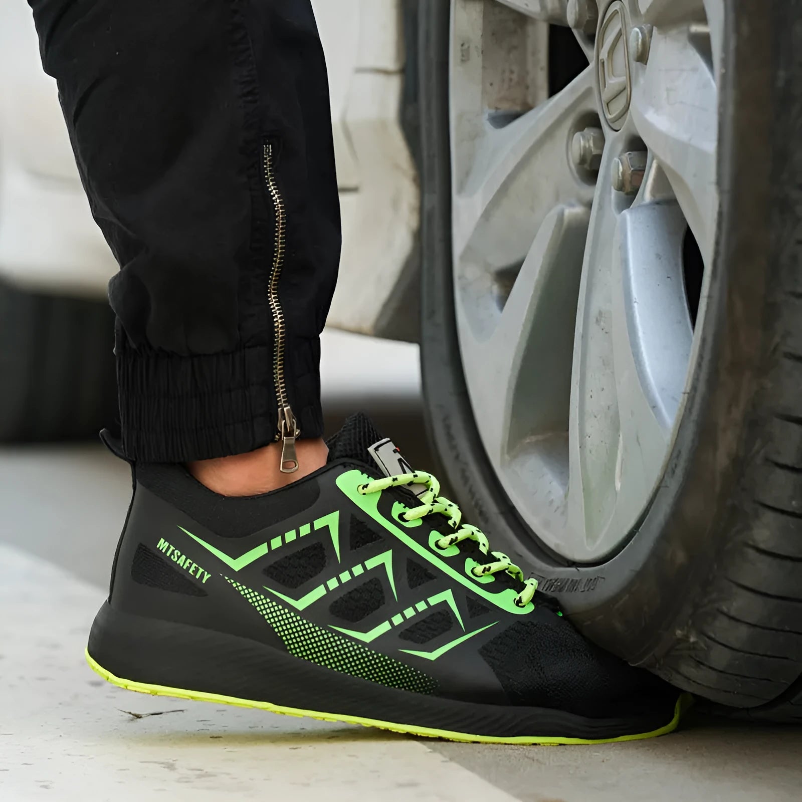 Black labour protection shoes with steel toe caps, lace-up front, and flat-knitted uppers for workplace safety