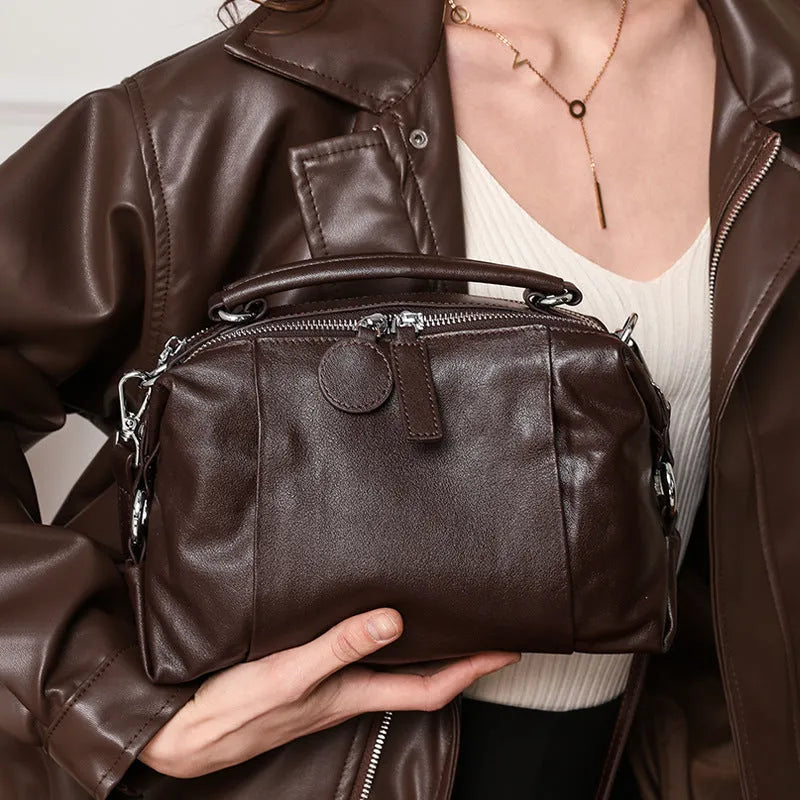 First layer cowhide leather one-shoulder messenger bag in brown with visible sewing thread and pillow shape