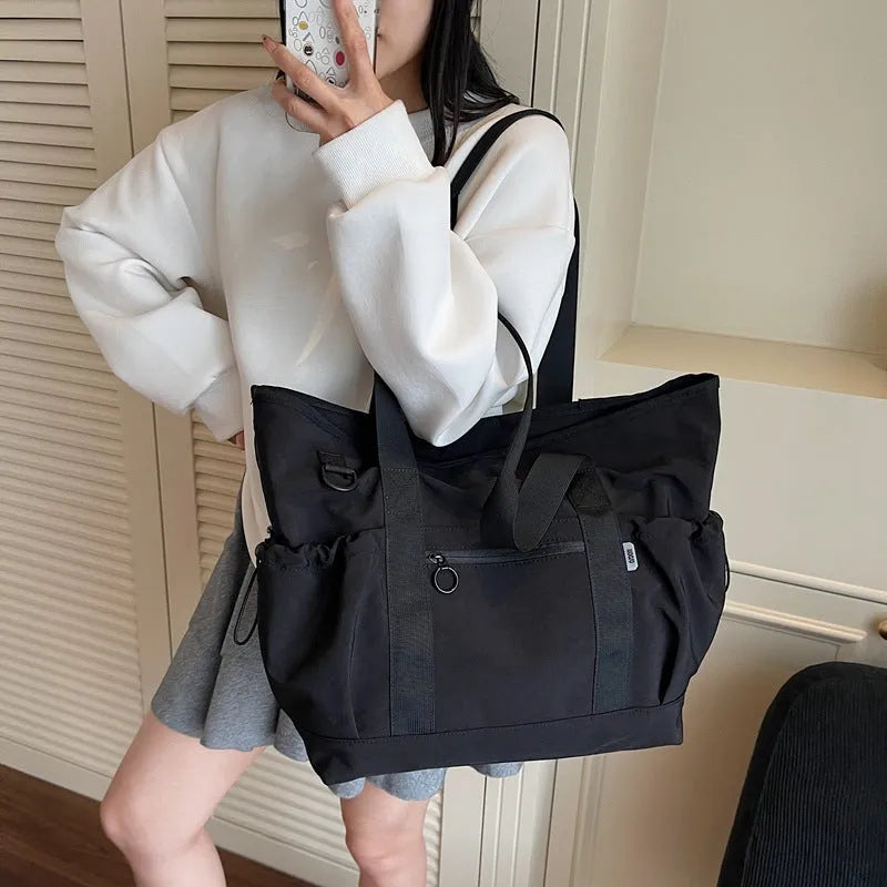 Women's lightweight Oxford cloth travel bag for yoga and fitness in grey colour with letter pattern.