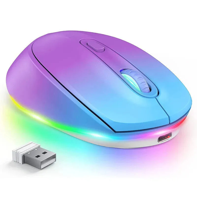 Compact white wireless mouse with ergonomic shape on a desk next to a laptop