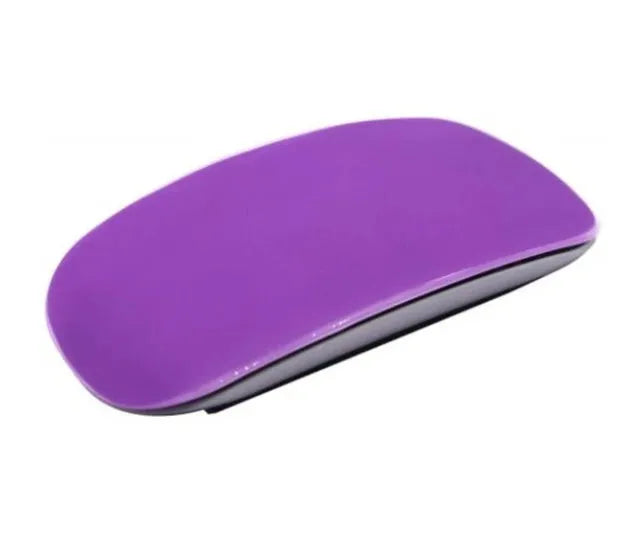 Silicone Magic Mouse cover skin in black on a white desk next to an Apple Magic Mouse