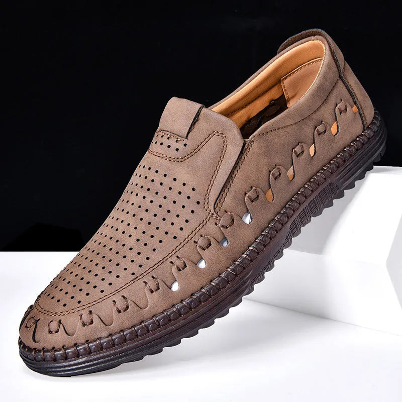 Men's brown slip-on casual shoes with a round toe and flat heel, showing hollowed-out design details.