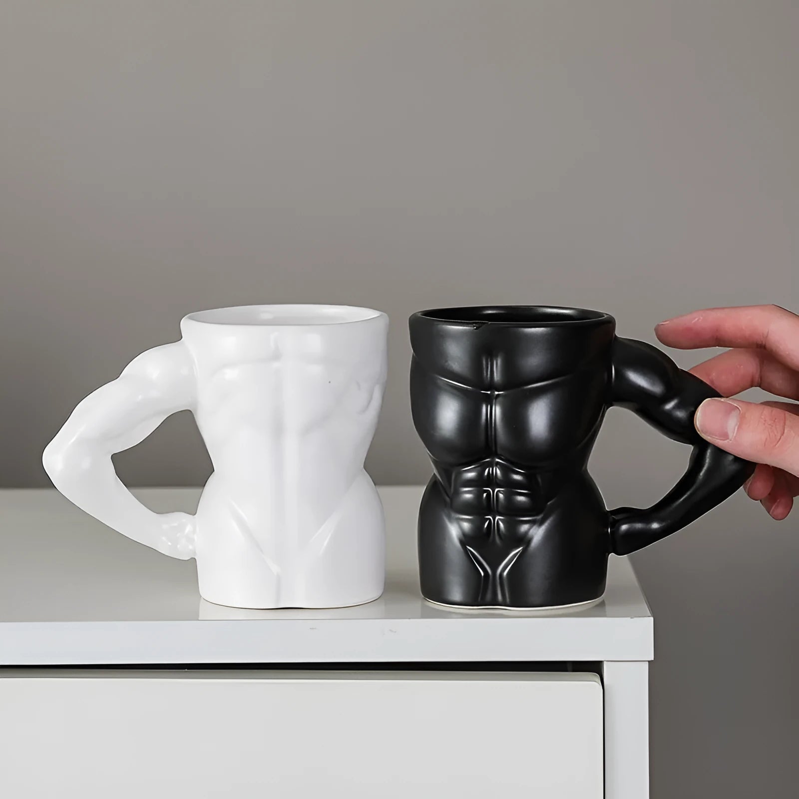 Matte black ceramic mug with muscle design and 300ml capacity