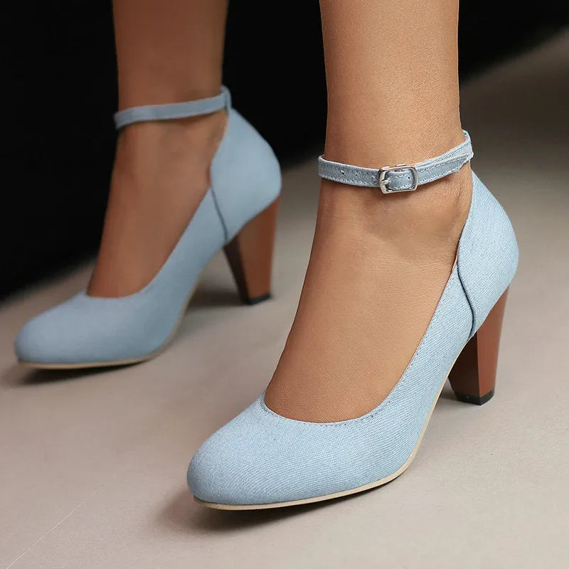 Women's blue denim platform high heels with an ankle buckle and a thick rubber sole.