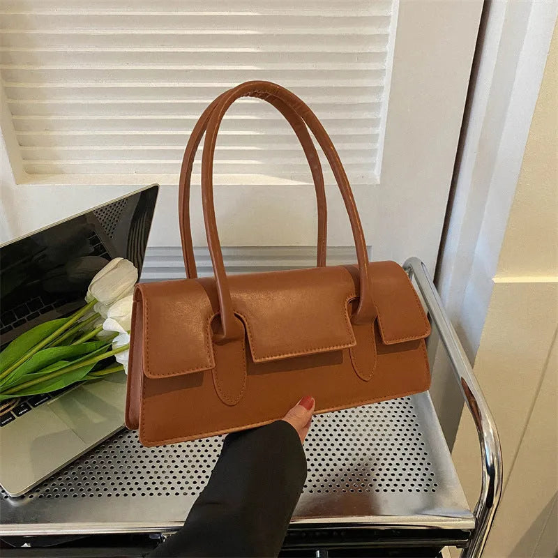 Women's square shoulder bag in black with stitching detail and single shoulder strap