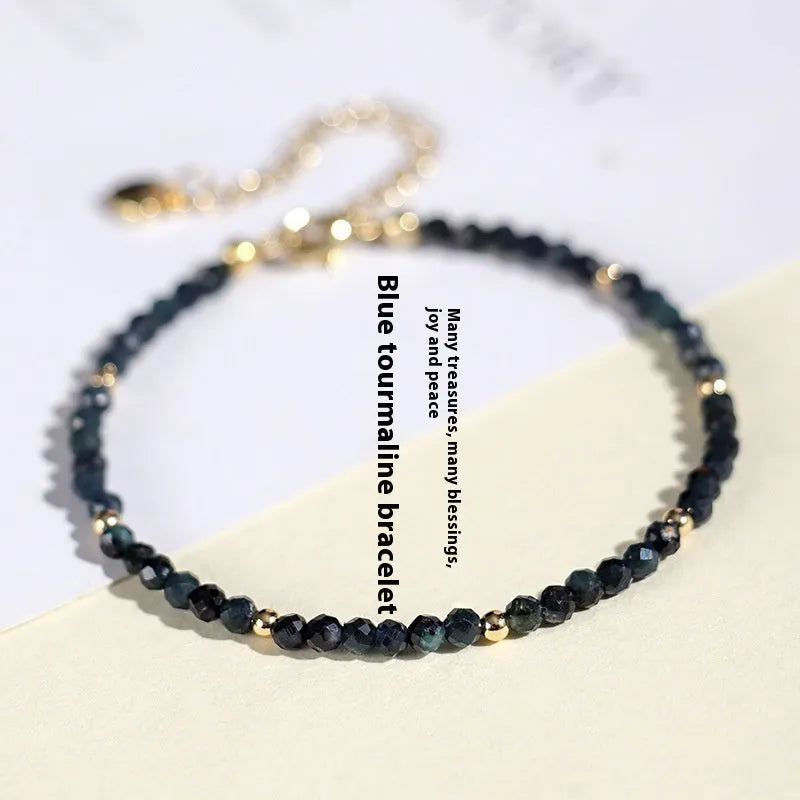 Blue tourmaline beaded bracelet with spacer beads on wrist showing 3mm gemstone size