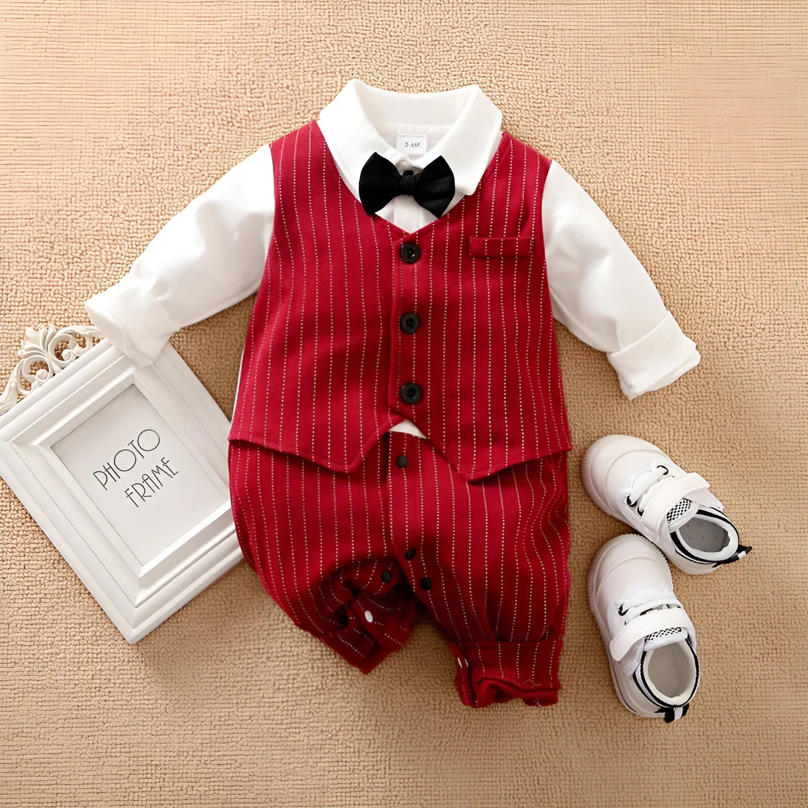 Wine red cotton baby boy romper suit with long sleeves and single-breasted closure.