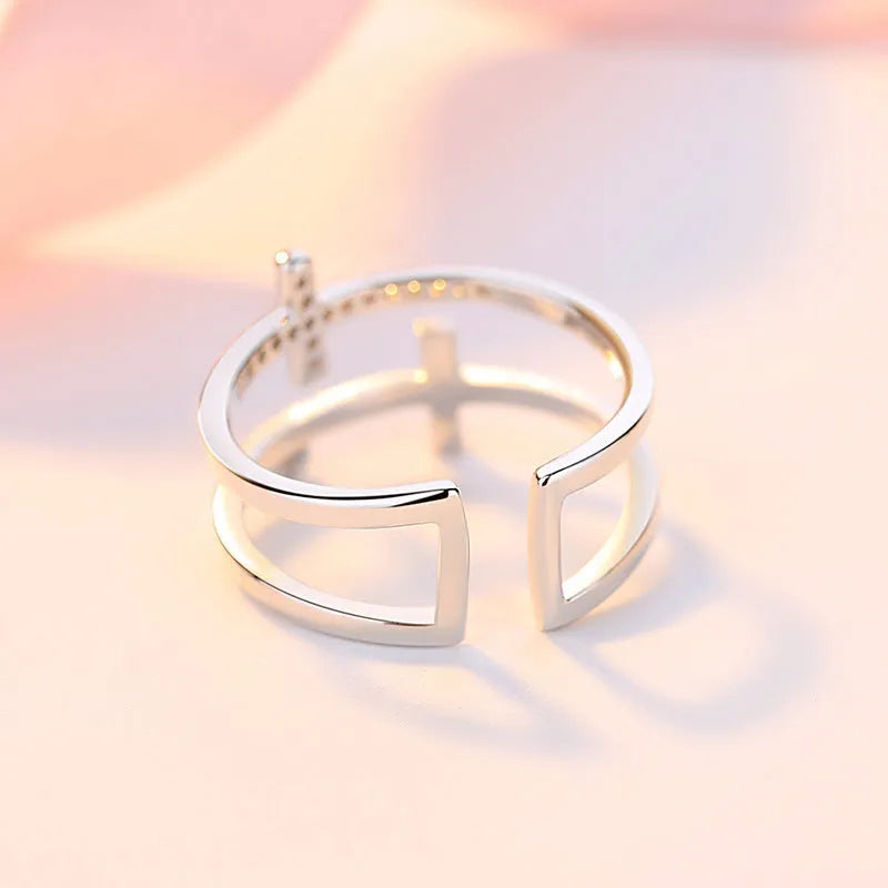 Adjustable double cross geometric copper ring with white gold finish and inlaid zircon gems.