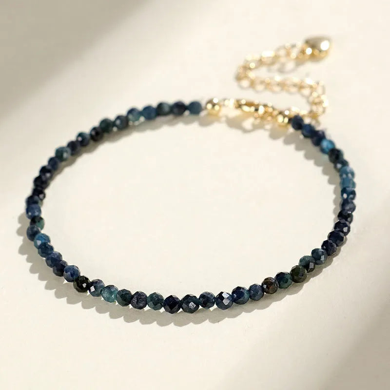 Blue tourmaline beaded bracelet with spacer beads on wrist showing 3mm gemstone size