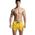 Men's quick-drying nylon beach shorts in yellow, loose fit for running and swimming