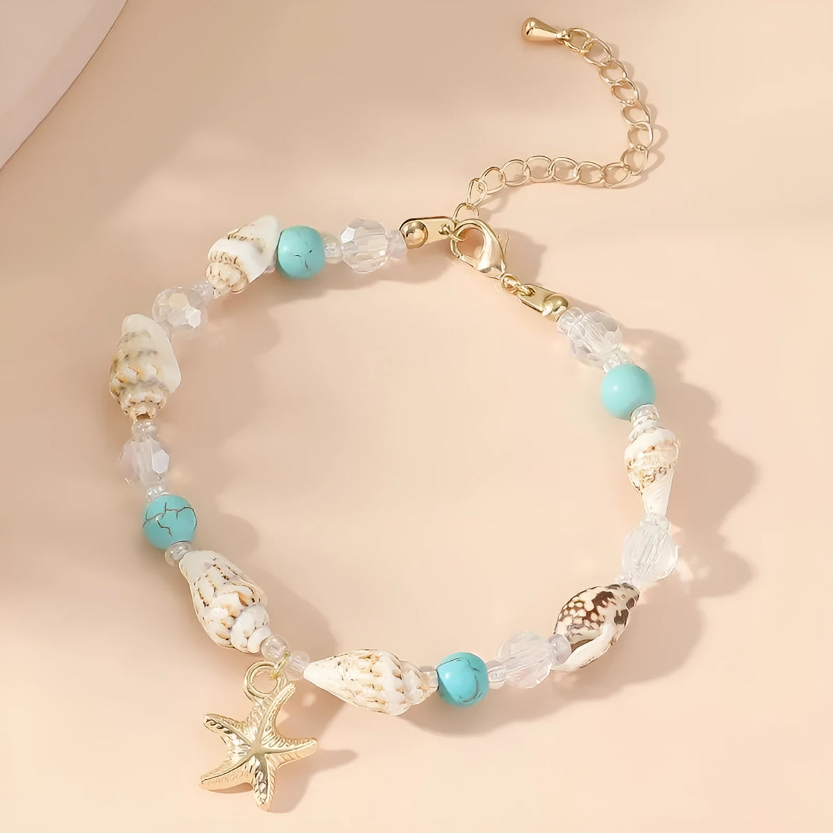 Alloy shell crystal beads bracelet with starfish pendant and conch beads on white background