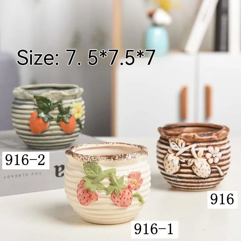 Three breathable stoneware succulent flower pots in hand-painted glaze colours on a tabletop with small succulents inside