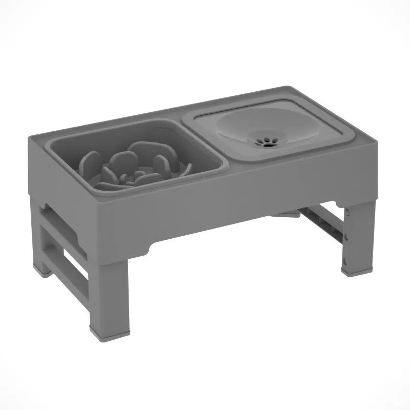 Adjustable height black and grey plastic dog feeder stand with two stainless steel bowls at medium setting