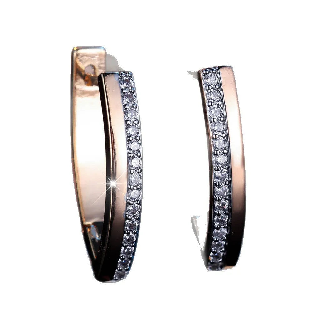 Close-up of women's geometric V-shaped champagne gold ear clips with a clip-on back.