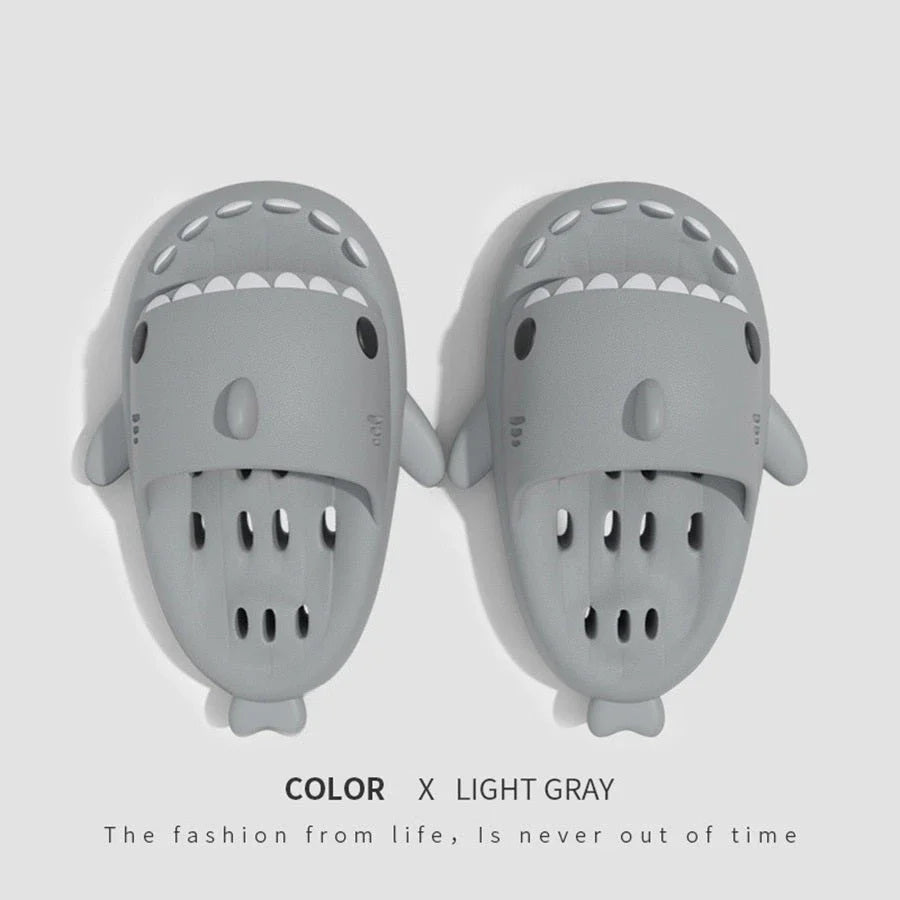 Shark-inspired shower slides with drain holes, featuring authentic shark design details and quick-drying EVA material