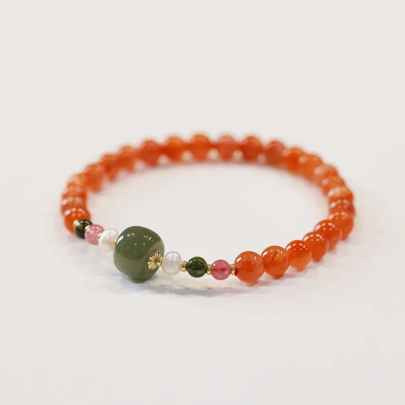 Close-up of a women's bracelet with round cherry red South Red Agate beads in a retro ethnic style.