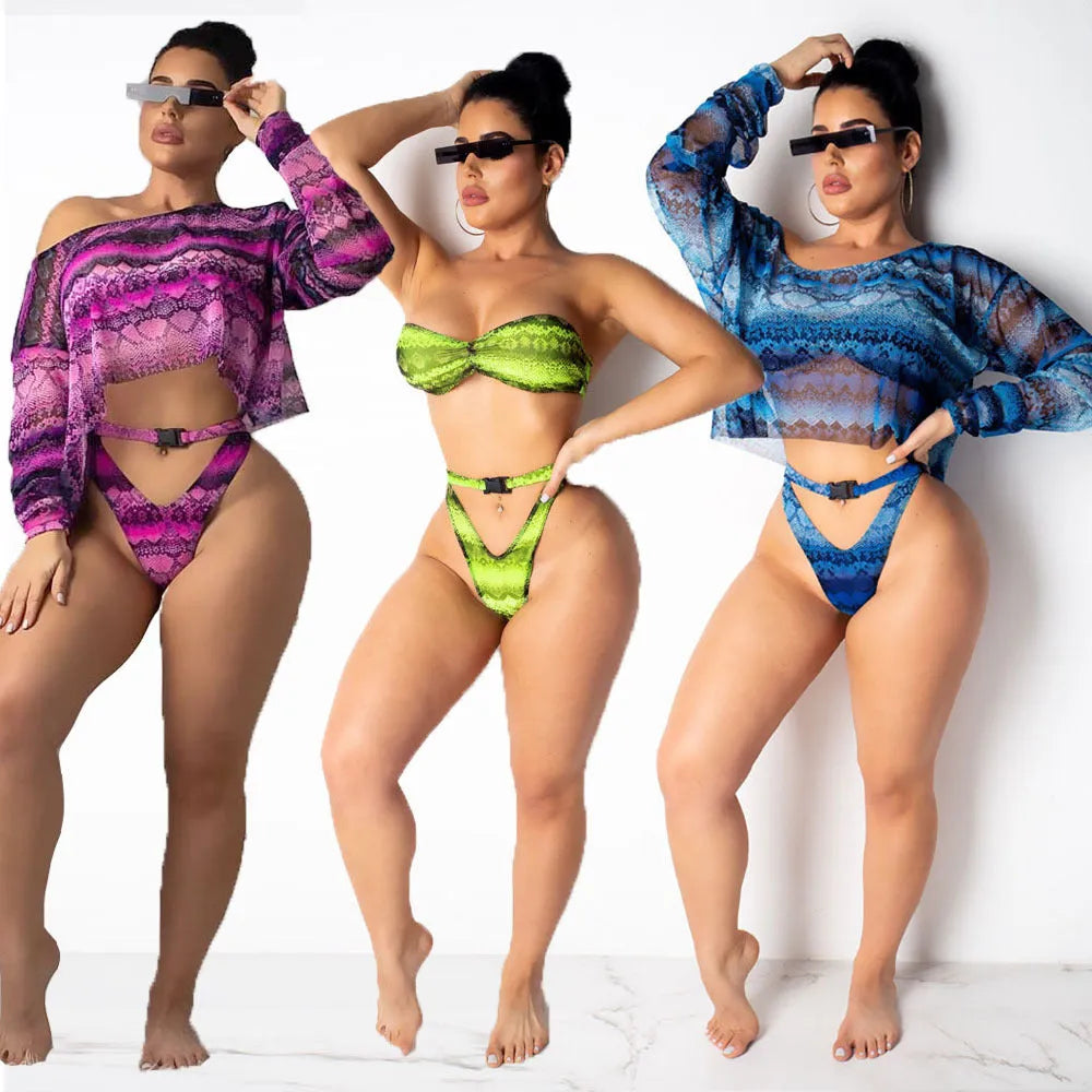 Women's purple snakeskin print bikini set with long sleeves and split shorts laid flat
