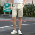 Men's loose elastic fifth pants in solid colour polyester fabric on a size chart