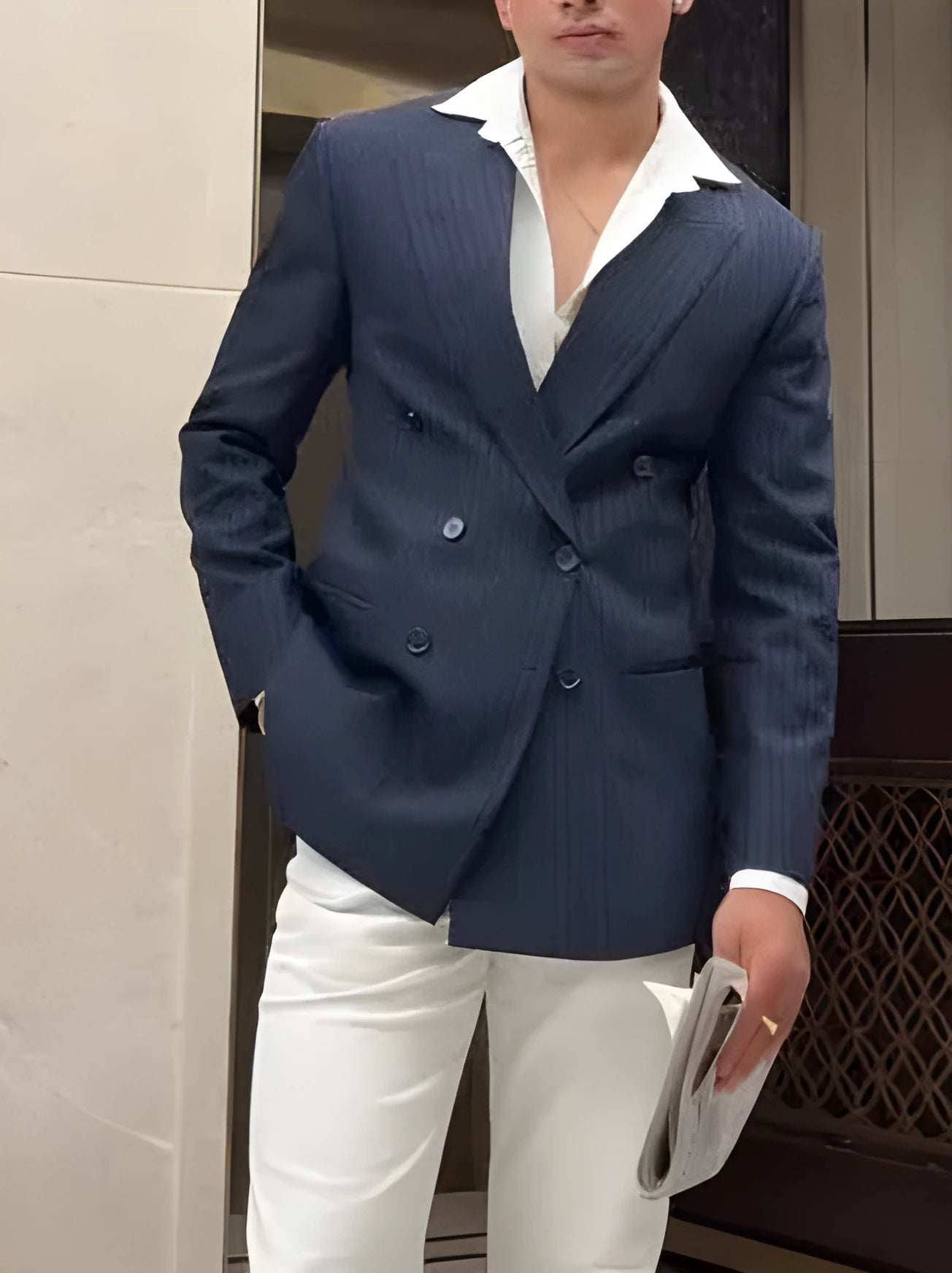 Men's striped double-breasted blazer on hanger showing regular length and structured front