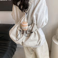 Ultra-light pleated crossbody student cloth bag in folded position showing split pocket design