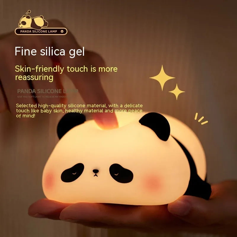 Cute cartoon panda silicone night light for children on a bedside table.