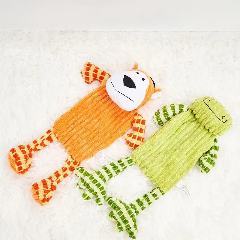 Green and orange plush dog toy with squeaker for aggressive chewing and teeth grinding