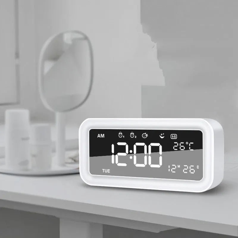 Blue rectangular multifunctional LED atmosphere light alarm clock with digital display on a wooden surface.