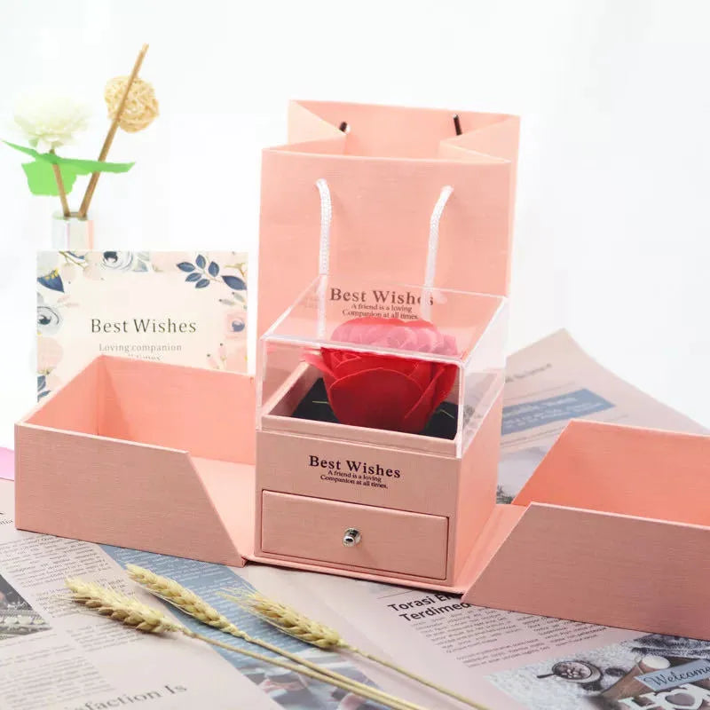Blue gift box with a built-in plastic red rose, holding earrings and a necklace inside.