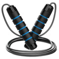 Steel wire jump rope with black PP handle on a dark background for fitness training