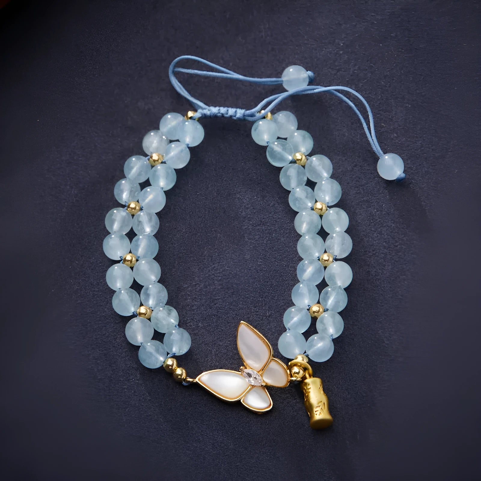 Handmade women's woven bracelet with 6mm aquamarine beads and butterfly decoration in retro style