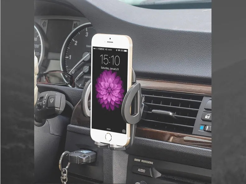 Black plastic universal car phone holder mounted on a car air vent
