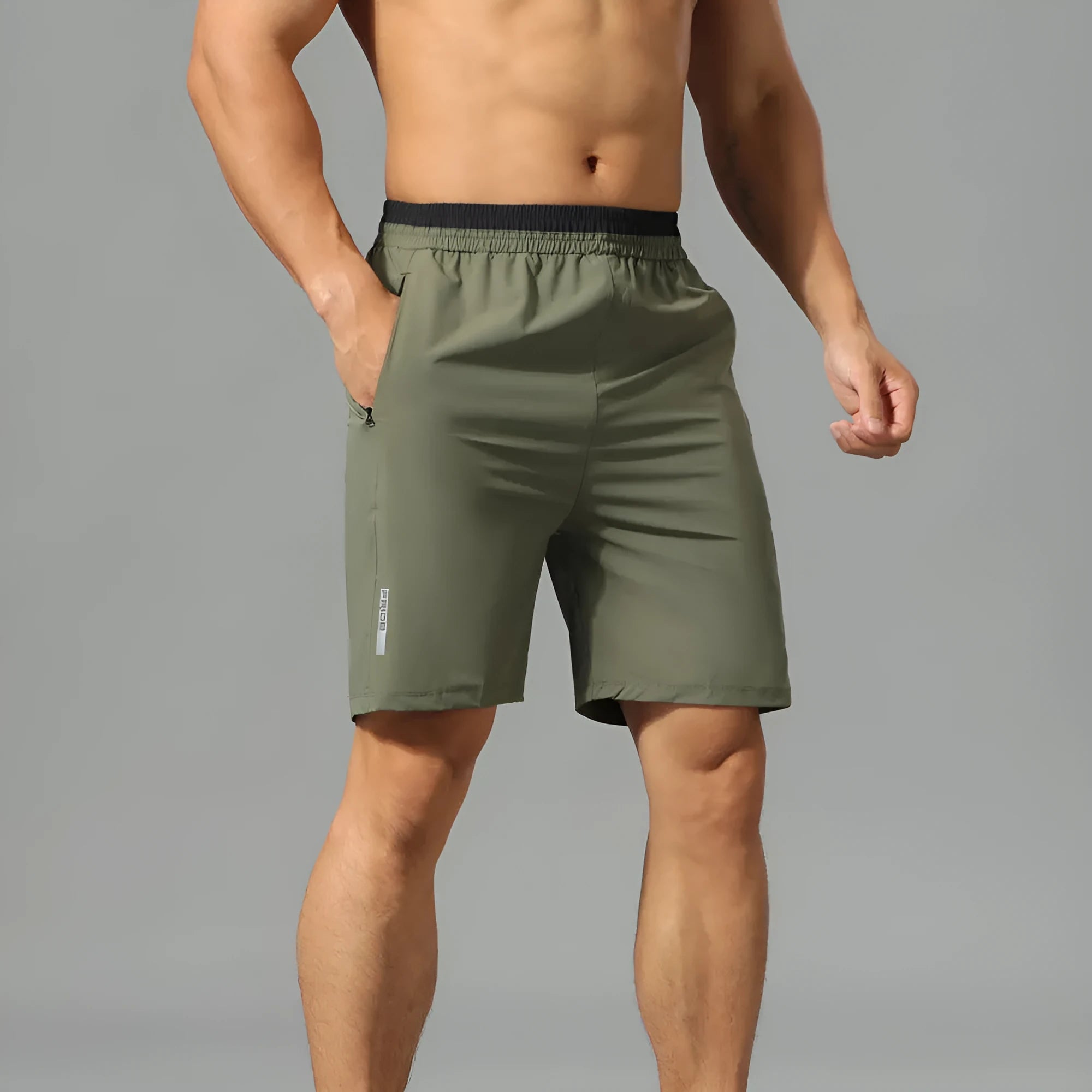 Man wearing grey loose-fit cropped Ice Silk pants for running or leisure.