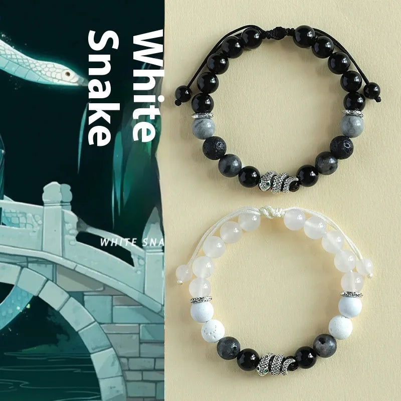 A matching couple bracelet set: one black agate and one white agate bracelet with snake chain clasps.