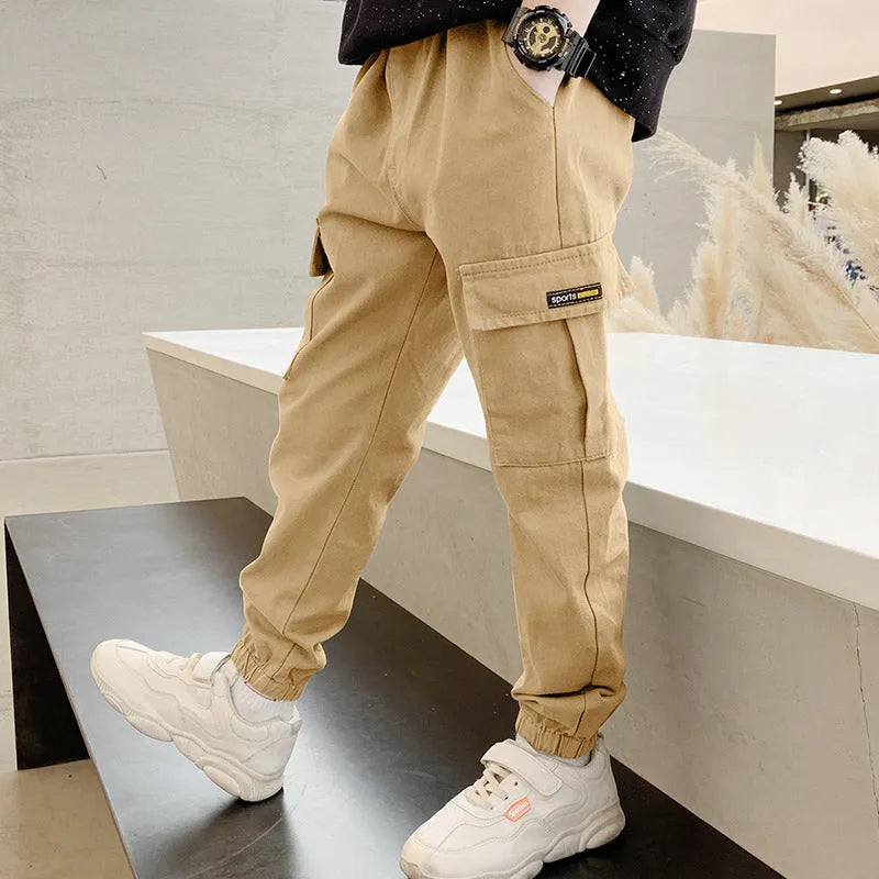Boys' casual cotton trousers in army green, shown laid flat with size label visible.